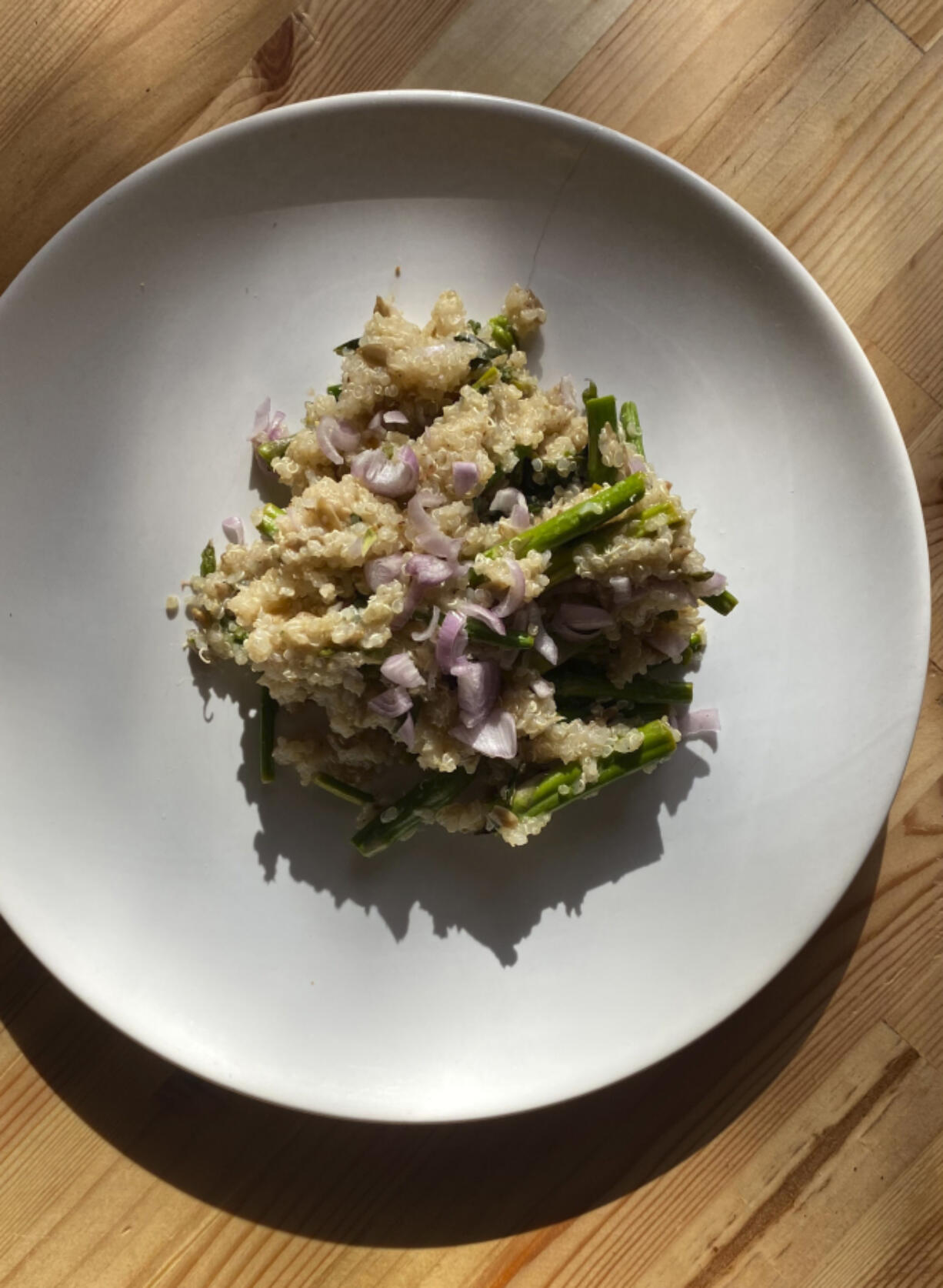 This image shows a recipe for quinoa pilaf with asparagus, from the book &ldquo;The High-Protein Vegan Cookbook for Athletes: 70 Whole-Foods Recipes to Fuel Your Body&rdquo; by Jenna Braddock and Ivy Stark.