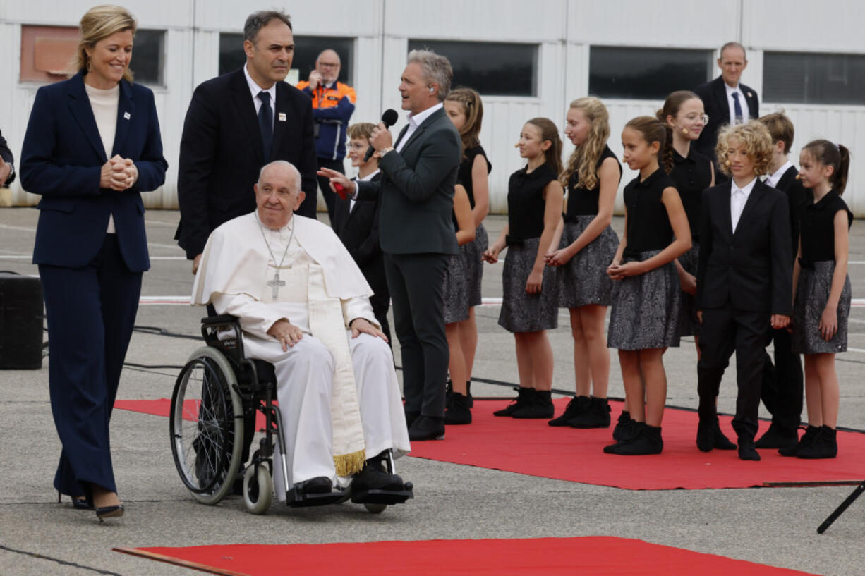 Pope Francis is accompanied by Belgian authorities during the farewell ceremony at Melsbroek Air Base at the end of a four-day visit to Belgium and Luxembourg, Sunday, Sept. 29, 2024.