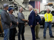 President Joe Biden, third from right, greets workers from Dairyland Power Cooperative and Vernon Electric Cooperative during a visit to Vernon Electric in Westby, Wis., Thursday, Sept. 5, 2024. Biden is in Wisconsin to promote his Investing in America agenda.