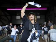 Cristina Green waves a towel to machinists and fellow union members for a &quot;stop work meeting&quot; and strike sanction at T-Mobile Park in Seattle, July 17, 2024.