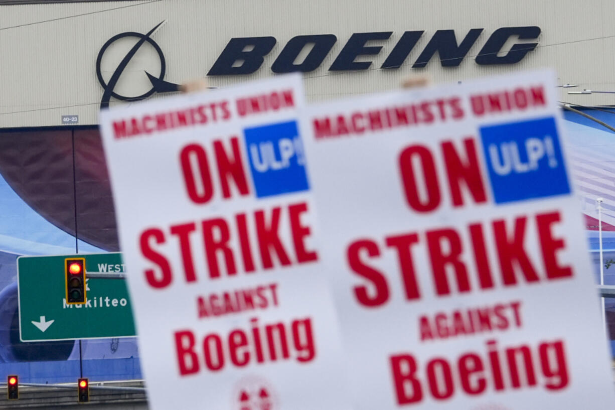 Boeing workers wave picket signs as they strike after union members voted to reject a contract offer, Sunday, Sept. 15, 2024, near the company&#039;s factory in Everett, Wash.