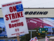 Boeing workers wave picket signs as they strike after union members voted to reject a contract offer, Sunday, Sept. 15, 2024, near the company&#039;s factory in Everett, Wash.