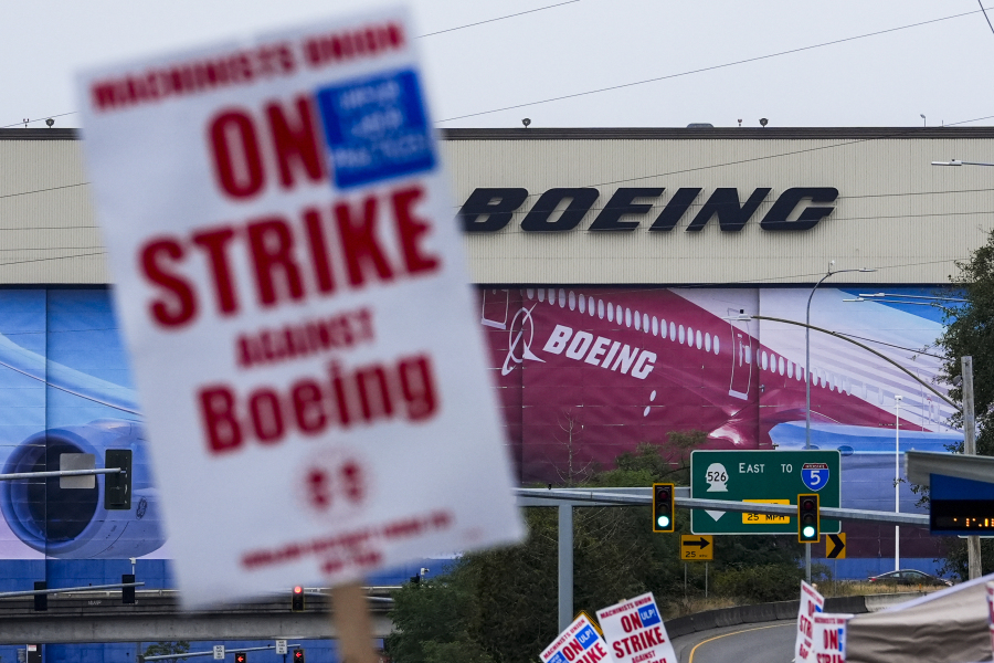 Boeing workers wave picket signs as they strike after union members voted to reject a contract offer, Sunday, Sept. 15, 2024, near the company&#039;s factory in Everett, Wash.