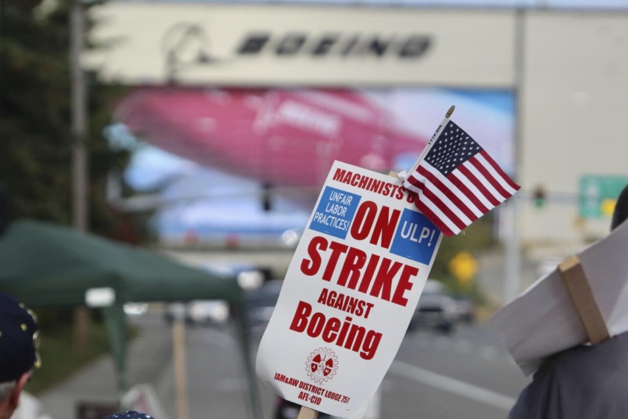 A strike sign is waved on the union machinist picket line near Boeing&#039;s factory in Everett, Washington, Thursday, Sept. 19, 2024.