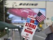 A strike sign is waved on the union machinist picket line near Boeing&#039;s factory in Everett, Washington, Thursday, Sept. 19, 2024.