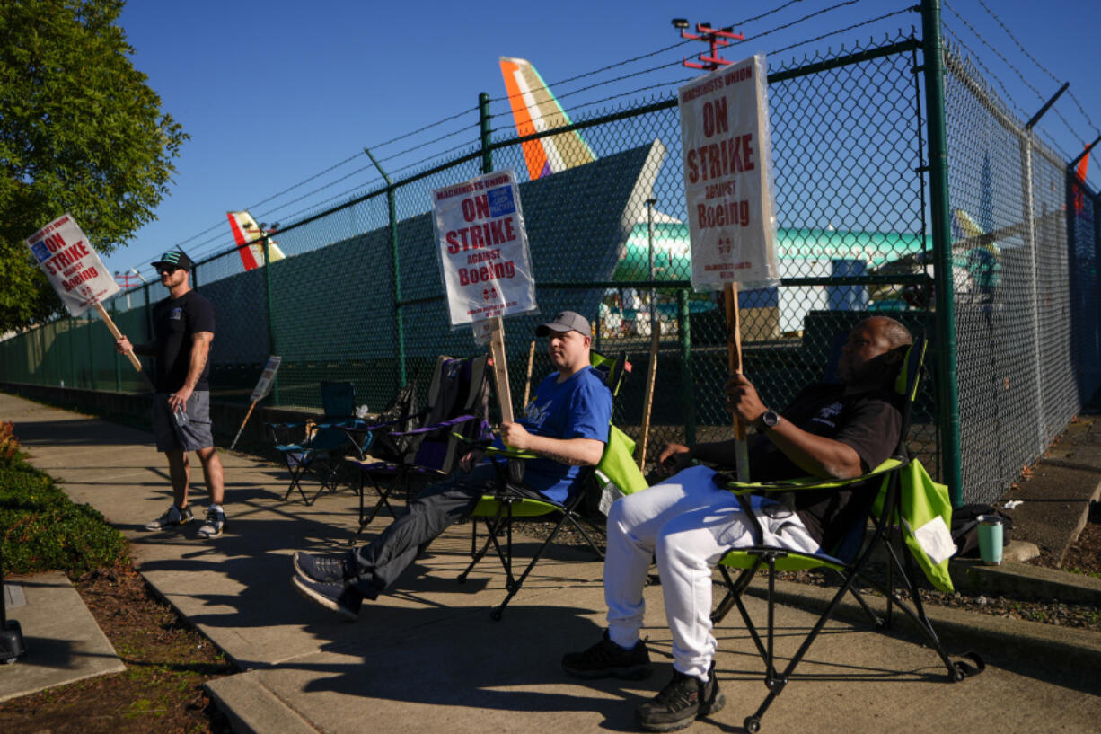 Boeing 737 Max aircrafts are seen behind fences as Boeing employees work the picket line while striking Tuesday, Sept. 24, 2024, next to the company&rsquo;s facilities in Renton, Wash.