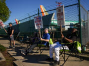 Boeing 737 Max aircrafts are seen behind fences as Boeing employees work the picket line while striking Tuesday, Sept. 24, 2024, next to the company&rsquo;s facilities in Renton, Wash.