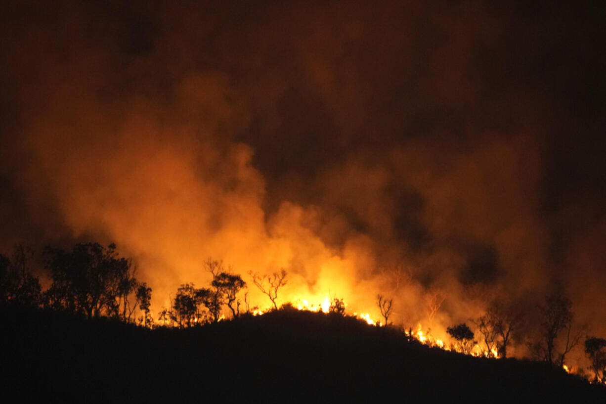 Fires spread through the environmental protection area of Pouso Alto, in Chapada dos Veadeiros National Park, during dry season, in Colinas do Sul, Goias state, Brazil, Monday, Sept. 9, 2024.