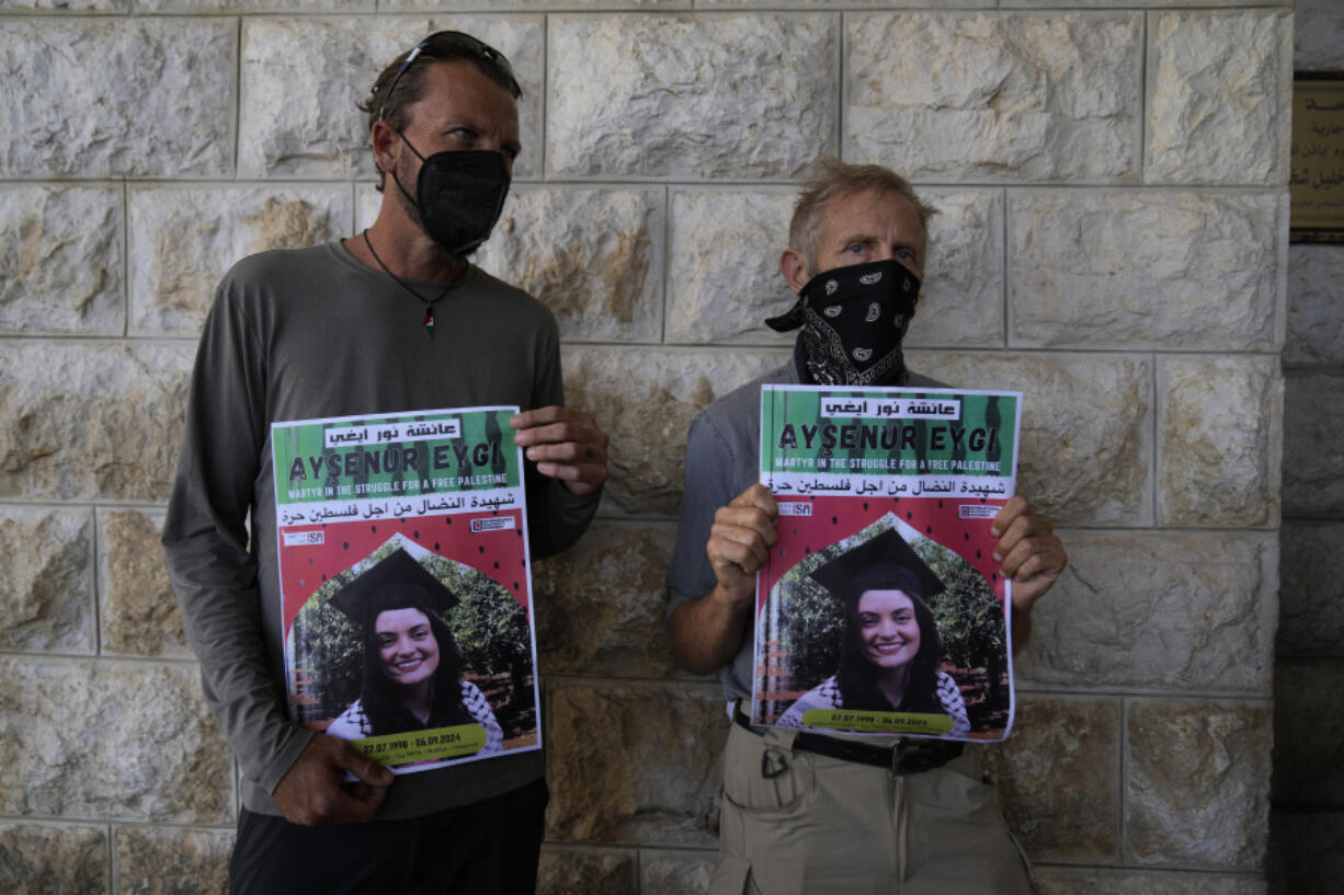 Two fellow activists of Aysenur Ezgi Eygi, 26, who a witness says was fatally shot by Israeli soldiers while participating in an anti-settlement protest in the West Bank, carry posters with her name and photo during Eygi&#039;s funeral procession in the West Bank city of Nablus, Monday, Sept. 9, 2024.