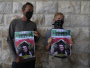 Two fellow activists of Aysenur Ezgi Eygi, 26, who a witness says was fatally shot by Israeli soldiers while participating in an anti-settlement protest in the West Bank, carry posters with her name and photo during Eygi&#039;s funeral procession in the West Bank city of Nablus, Monday, Sept. 9, 2024.