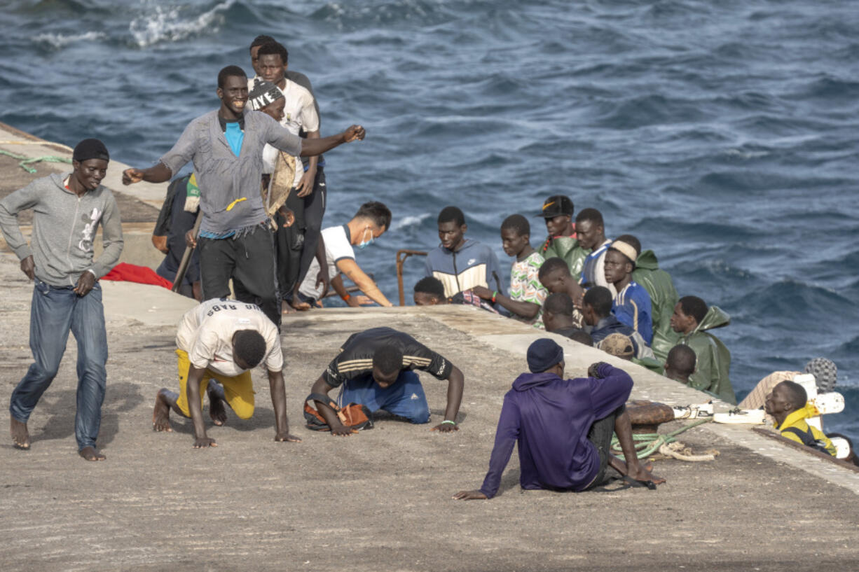 CORRECTS TO DELETE THE EXTRANEOUS WORD OF &quot;UNAUTHORIZED&quot; - FILE - Migrants react as they arrive at the port in La Restinga on the Canary island of El Hierro, Spain, on, Aug. 19, 2024.