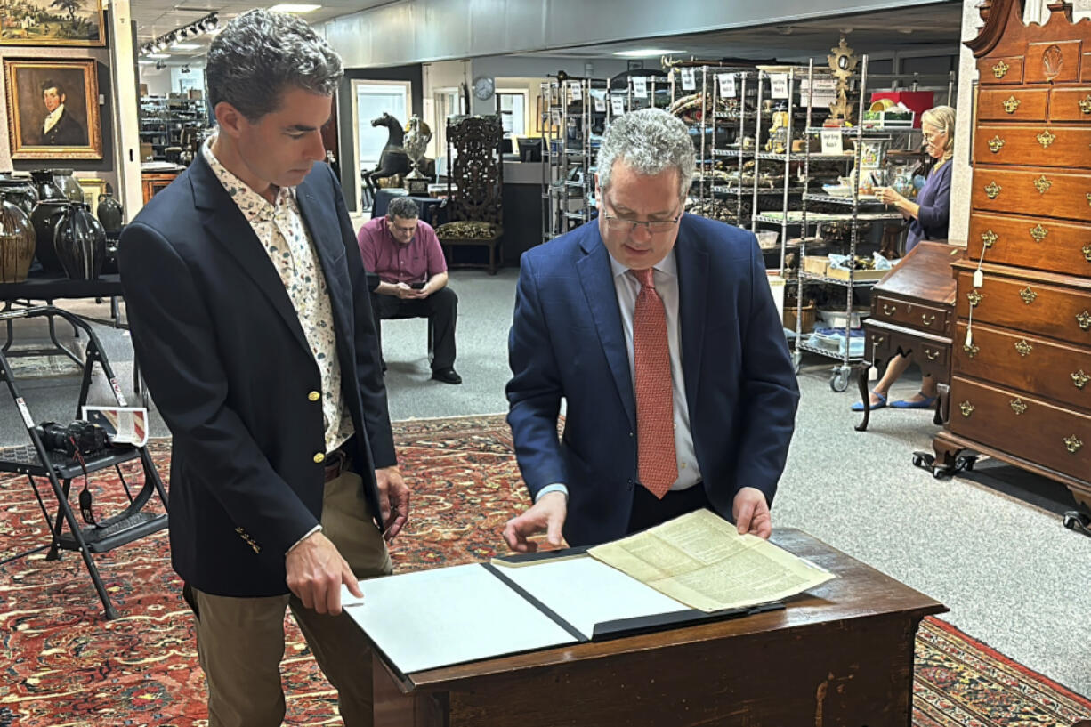 CORRECTS NAME TO BRUNK AUCTIONS - Auctioneer Andrew Brunk, left, and historian Seth Kaller, right show off a 1787 copy of the U.S. Constitution that will be put up for auction on Sept. 28, 2024 at Brunk Auctions in Asheville, N.C., on Thursday, Sept. 5.