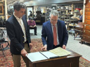 CORRECTS NAME TO BRUNK AUCTIONS - Auctioneer Andrew Brunk, left, and historian Seth Kaller, right show off a 1787 copy of the U.S. Constitution that will be put up for auction on Sept. 28, 2024 at Brunk Auctions in Asheville, N.C., on Thursday, Sept. 5.