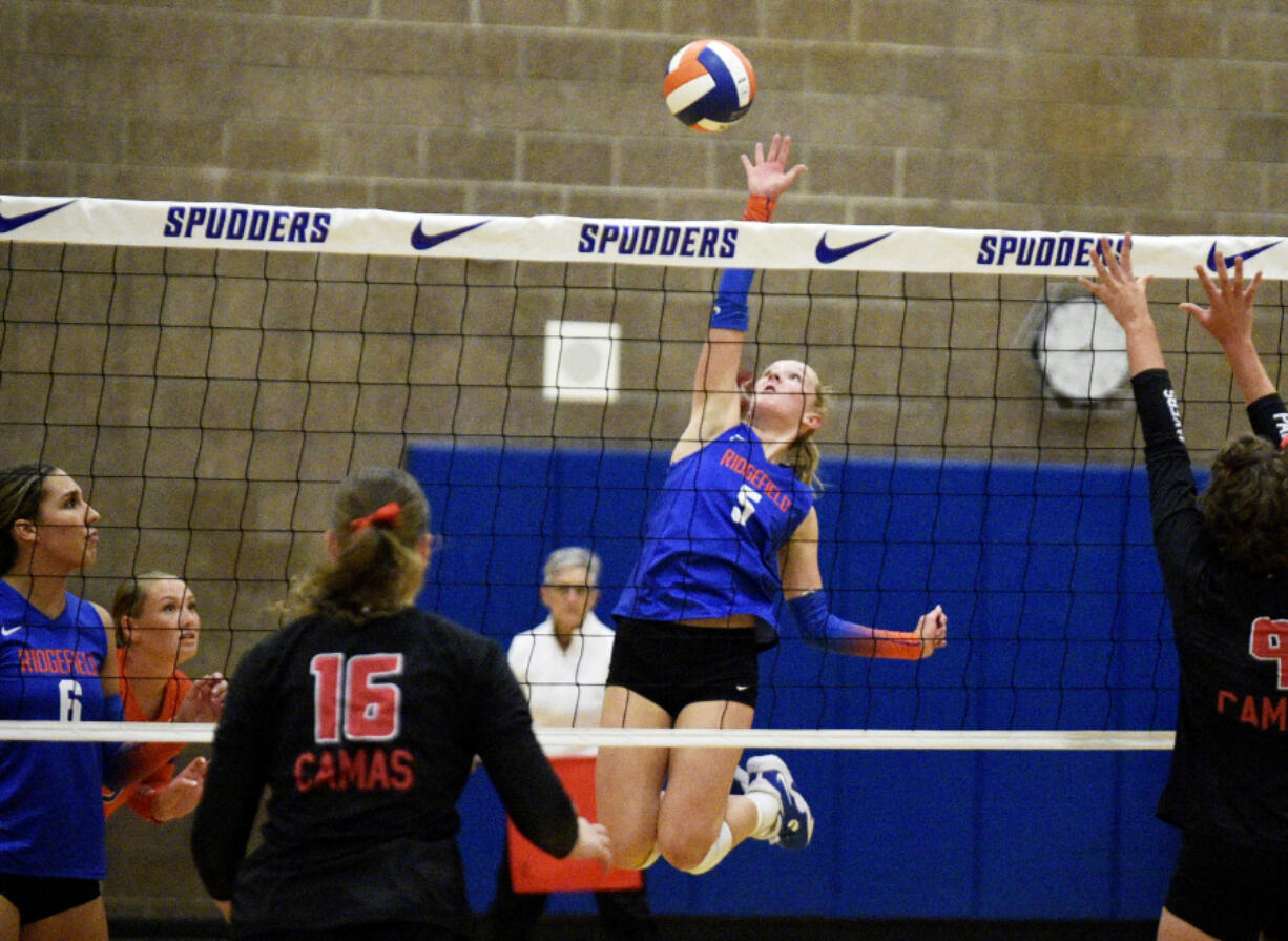 Ridgefield&#039;s Ella Burke hits a spike during a season-opening volleyball match against Camas on Monday, Sept. 9, 2024 at Ridgefield High School.