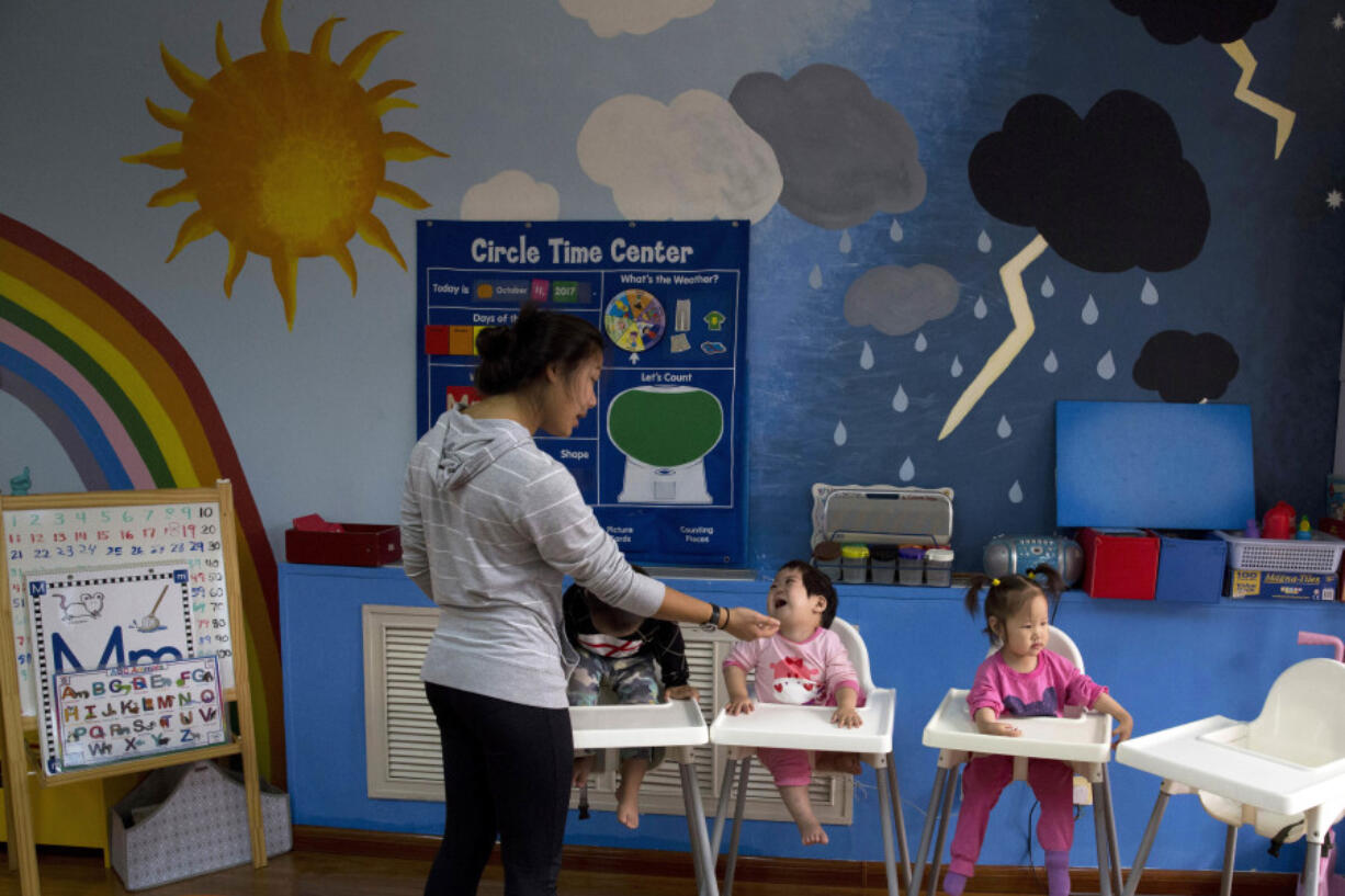 FILE - Children attend classes at a foster home of the New Hope Foundation on the outskirts of Beijing, China on Oct. 11, 2017.