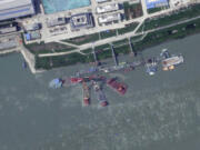 This satellite image from Planet Labs PBC shows what appears to be a sunken Chinese submarine at a shipyard near Wuhan, China, June 15, 2024.