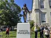 Sculptor Benjamin Victor (in baseball cap) speaks to Steven McAuliffe, former husband of teacher Christa McAuliffe who died when the space shuttle Challenger broke apart in 1986, as they stand next to a statue unveiled on what would&#039;ve been Christa McAuliffe&#039;s 76th birthday, Monday, Sept. 2, 2024, in Concord, N.H.