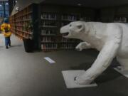 A polar bear sculpture greets patrons, Wednesday, Aug. 7, 2024, at the Churchill Public Library in Churchill, Manitoba. (AP Photo/Joshua A.