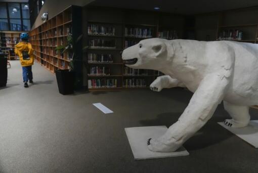 A polar bear sculpture greets patrons, Wednesday, Aug. 7, 2024, at the Churchill Public Library in Churchill, Manitoba. (AP Photo/Joshua A.