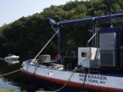 A boat, left, passes by the NH3 Kraken, a tugboat powered by ammonia, Friday, Sept. 13, 2024, in Kingston, N.Y.