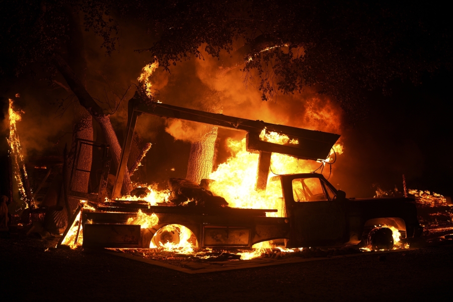 A vehicle burns from the Airport Fire Tuesday, Sept. 10, 2024, in El Cariso, an unincorporated community in Riverside County, Calif.