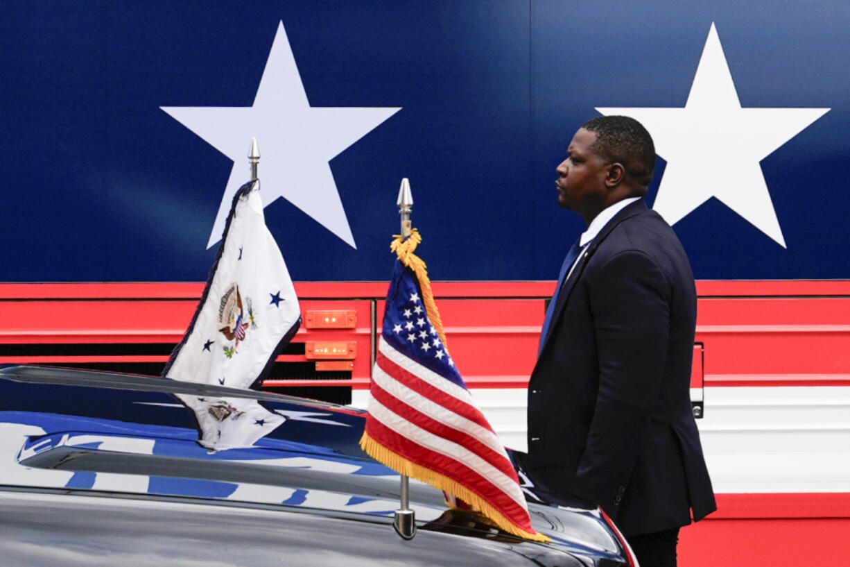 FILE - A U.S. Secret Service agent stands watch outside a campaign bus for Democratic presidential nominee Vice President Kamala Harris and her running mate Minnesota Gov. Tim Walz, Aug. 18, 2024, in Rochester, Pa.