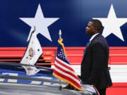 FILE - A U.S. Secret Service agent stands watch outside a campaign bus for Democratic presidential nominee Vice President Kamala Harris and her running mate Minnesota Gov. Tim Walz, Aug. 18, 2024, in Rochester, Pa.