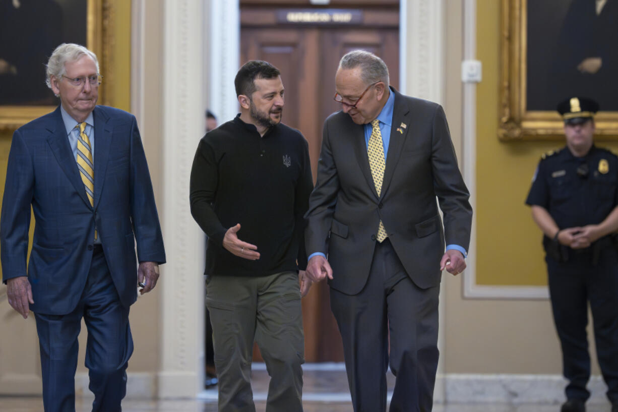 Ukrainian President Volodymyr Zelenskyy, center, walks with Senate Minority Leader Mitch McConnell, R-Ky., left, and Senate Majority Leader Chuck Schumer, D-N.Y., as he arrives for a briefing with lawmakers about the war effort against Russia, at the Capitol in Washington, Thursday, Sept. 26, 2024. (AP Photo/J.