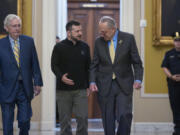 Ukrainian President Volodymyr Zelenskyy, center, walks with Senate Minority Leader Mitch McConnell, R-Ky., left, and Senate Majority Leader Chuck Schumer, D-N.Y., as he arrives for a briefing with lawmakers about the war effort against Russia, at the Capitol in Washington, Thursday, Sept. 26, 2024. (AP Photo/J.