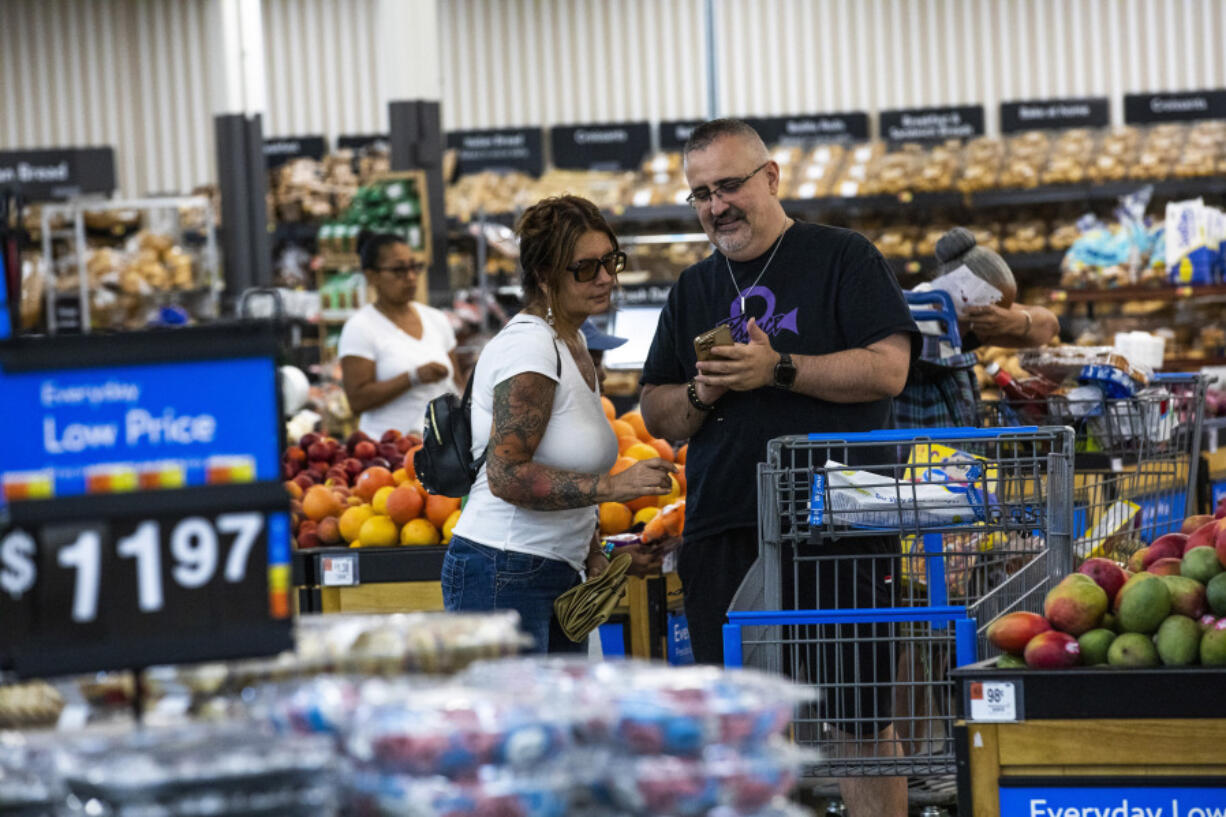 Shoppers pause in the produce section at a Walmart Superstore in Secaucus, New Jersey, July 11, 2024.