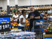 Shoppers pause in the produce section at a Walmart Superstore in Secaucus, New Jersey, July 11, 2024.