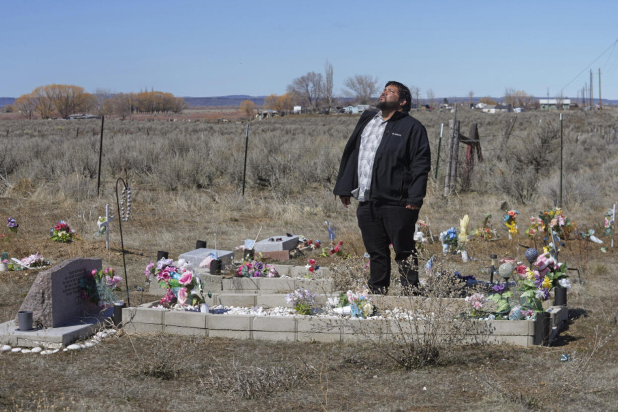 Shoshone-Paiute tribal member Michael Hanchor visits his mother&rsquo;s grave on March 15 in Owyhee, Nev., on the Duck Valley Indian Reservation that straddles the Nevada-Idaho border.