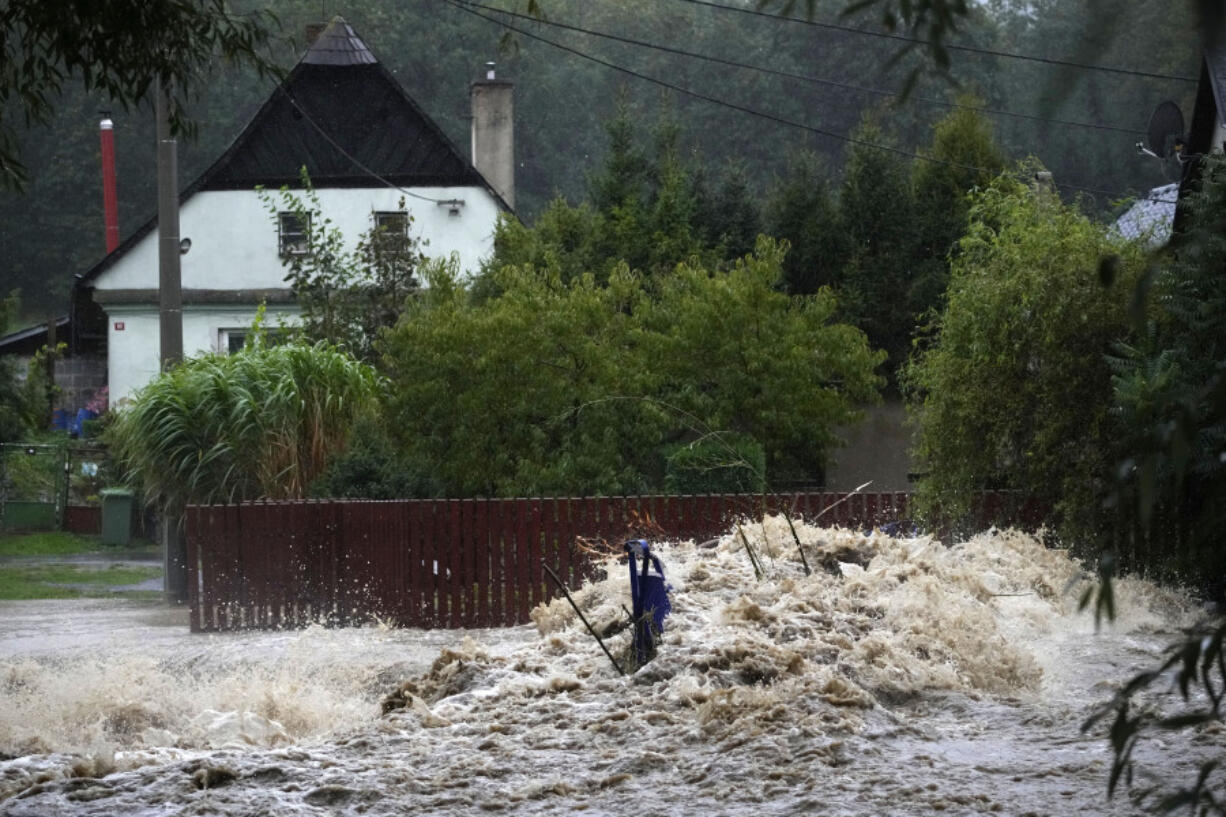 Debris collects on a small overpath on the Opavice River near Krnov, Czech Republic, Saturday, Sept. 14, 2024.