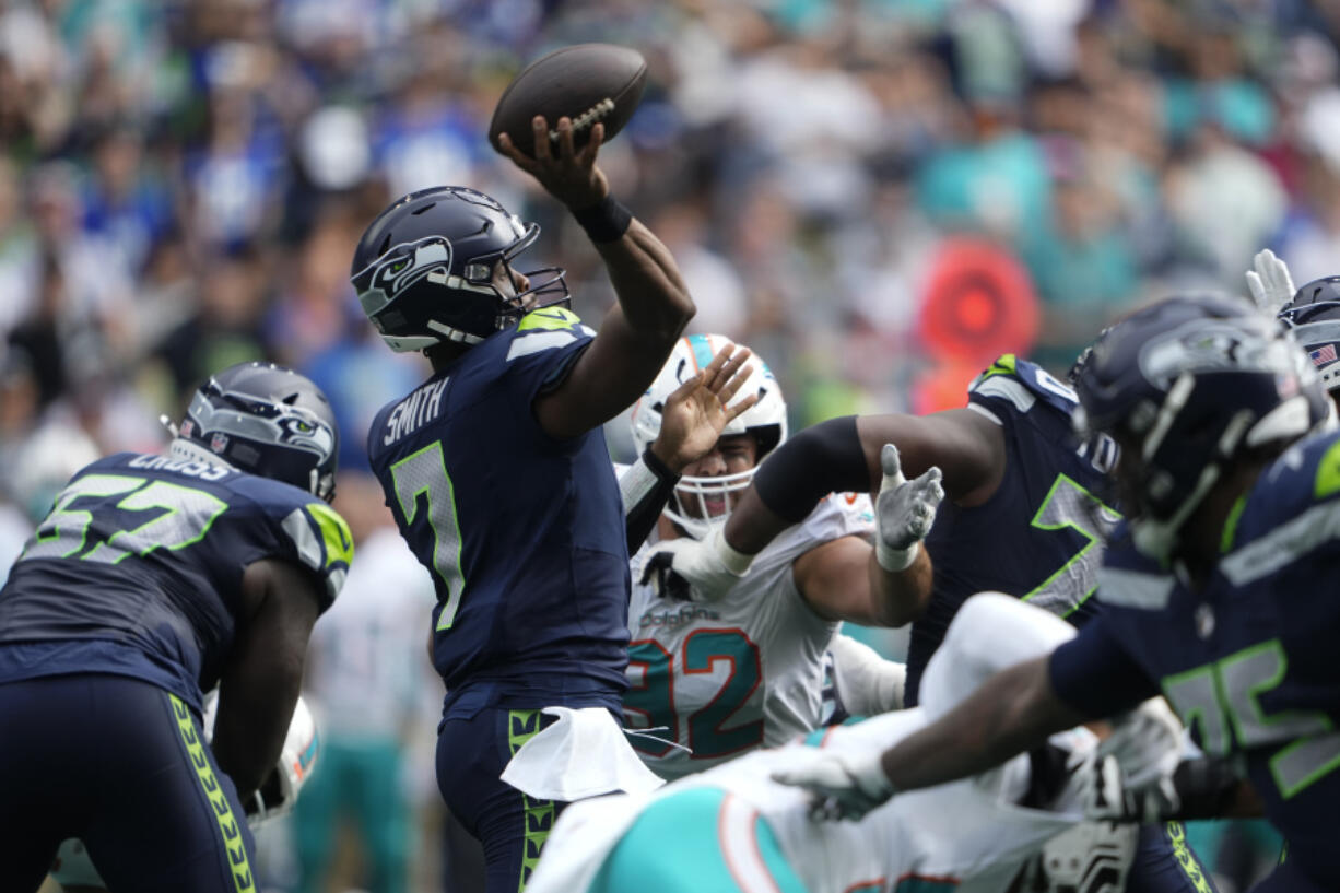 Seattle Seahawks quarterback Geno Smith (7) throws a touchdown pass to Seattle Seahawks wide receiver DK Metcalf, not pictured, during the first half of an NFL football game Sunday, Sept. 22, 2024, in Seattle.