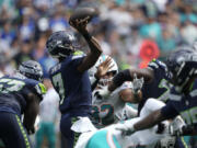 Seattle Seahawks quarterback Geno Smith (7) throws a touchdown pass to Seattle Seahawks wide receiver DK Metcalf, not pictured, during the first half of an NFL football game Sunday, Sept. 22, 2024, in Seattle.