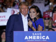 FILE - Arizona Republican gubernatorial candidate Kari Lake, right, speaks as former President Donald Trump listens during a rally, Oct. 9, 2022, in Mesa, Ariz.