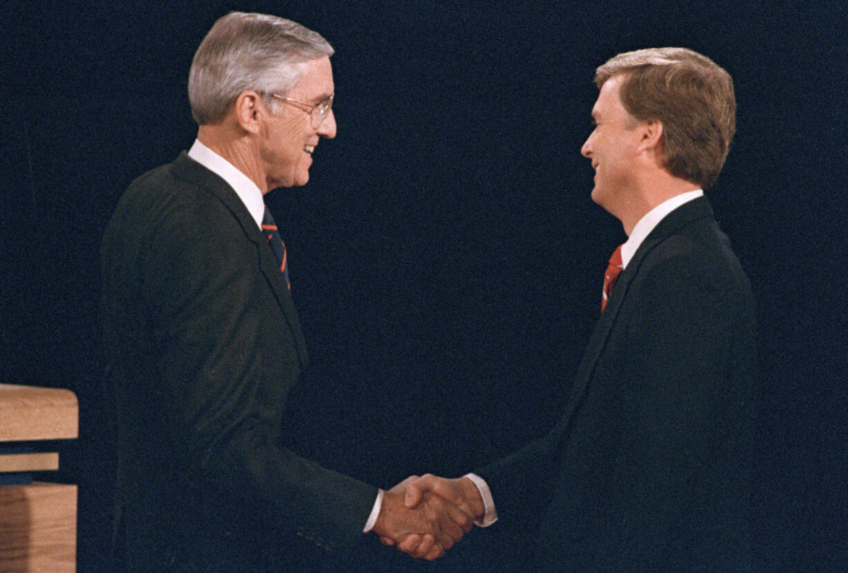 FILE - Sen. Lloyd Bentsen, D-Texas, left, shakes hands with Sen. Dan Quayle, R-Ind., before the start of their vice presidential debate at the Omaha Civic Auditorium, Omaha, Neb., Oct. 5, 1988.