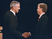 FILE - Sen. Lloyd Bentsen, D-Texas, left, shakes hands with Sen. Dan Quayle, R-Ind., before the start of their vice presidential debate at the Omaha Civic Auditorium, Omaha, Neb., Oct. 5, 1988.