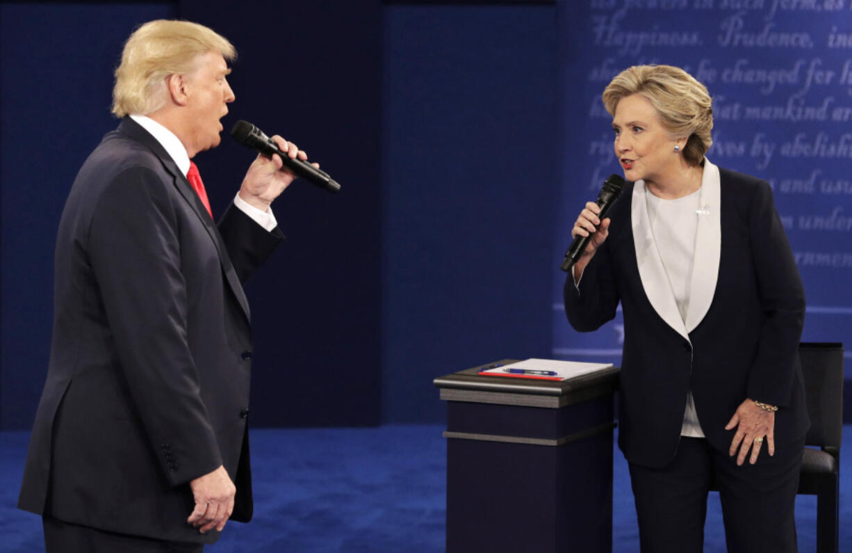 FILE - Republican presidential nominee Donald Trump, left, and Democratic presidential nominee Hillary Clinton speak during the second presidential debate in St. Louis, Oct. 9, 2016.