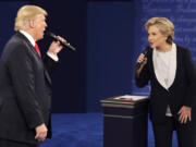 FILE - Republican presidential nominee Donald Trump, left, and Democratic presidential nominee Hillary Clinton speak during the second presidential debate in St. Louis, Oct. 9, 2016.