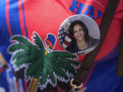 A woman wears a Haitian flag shirt and a pin supporting Democratic presidential nominee Vice President Kamala Harris, as members of South Florida&rsquo;s Haitian-American community listen to speakers during a rally to condemn hate speech and misinformation about Haitian immigrants, Sunday, Sept. 22, 2024, in North Miami, Fla.