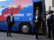 Democratic presidential nominee Vice President Kamala Harris and her running mate Minnesota Gov. Tim Walz exit their campaign bus in Savannah, Ga., Wednesday, Aug. 28, 2024.