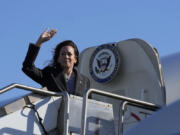 Democratic presidential nominee Vice President Kamala Harris waves while boarding Air Force Two in San Francisco, Saturday, Sept. 28, 2024.