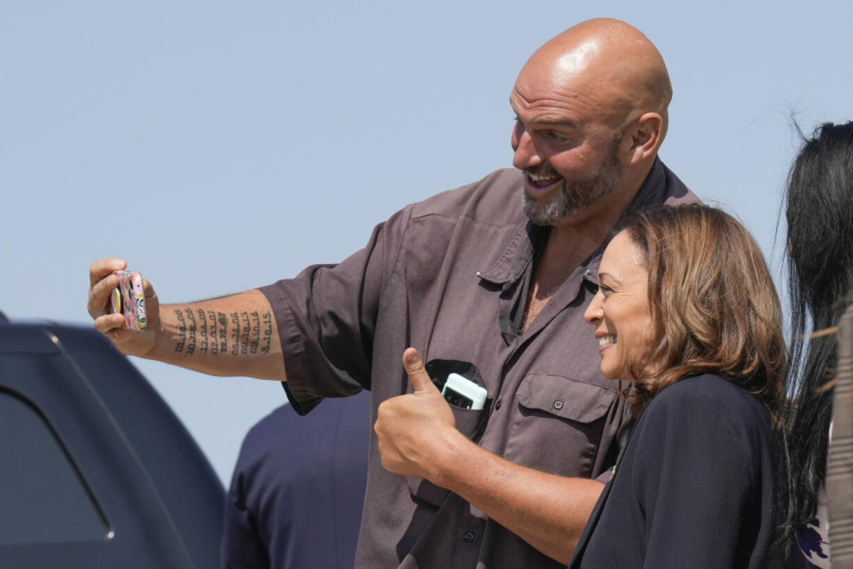 Democratic presidential nominee Vice President Kamala Harris arrives in Pittsburgh International Airport, in Coraopolis, Pa., Thursday, Sept. 5, 2024, and takes a selfie with Sen. John Letterman, D-Pa.