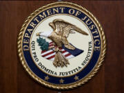 FILE - The seal of the Department of Justice, Aug. 1, 2023, at the Department of Justice in Washington. (AP Photo/J.