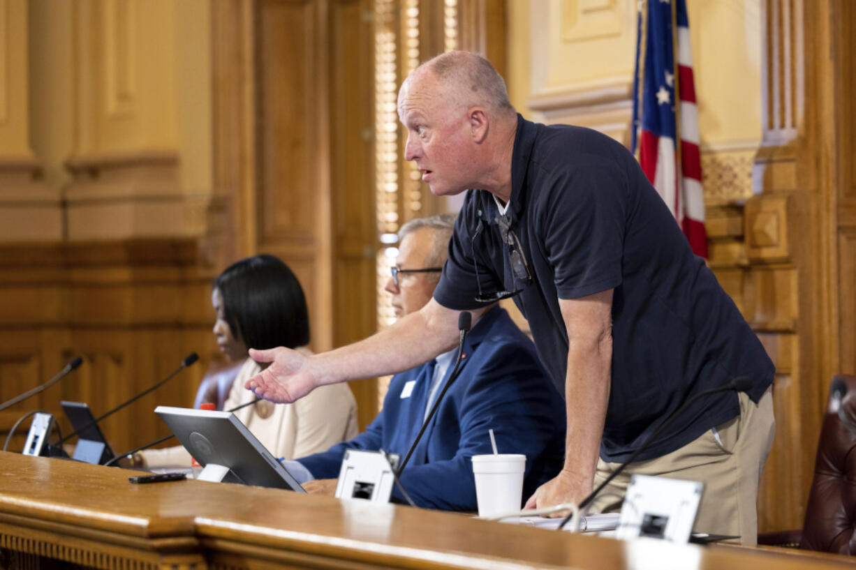 FILE - State Election Board member Rick Jeffares asks the crowd to settle down during a hastily planned State Election Board meeting at the Capitol in Atlanta, July 12, 2024.