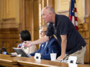 FILE - State Election Board member Rick Jeffares asks the crowd to settle down during a hastily planned State Election Board meeting at the Capitol in Atlanta, July 12, 2024.