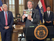 Missouri Attorney General Andrew Bailey holds up photos of candy-like products containing unregulated psychoactive cannabis ingredients that he says are being marketed to children during a press conference Tuesday, Sept. 10, 2024, at the governor&#039;s office at the state Capitol in Jefferson City, Mo. (AP Photo/David A.