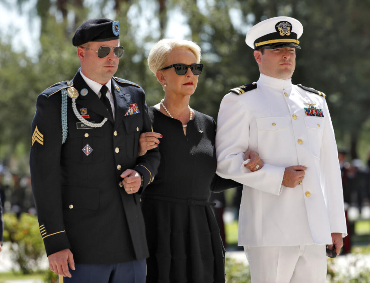 FILE - Cindy McCain, escorted by sons, Jack McCain, right, and Jimmy McCain, follow behind military personal carrying the casket of Sen. John McCain, R-Ariz., into the Capitol rotunda for a memorial service, Aug. 29, 2018, at the Capitol in Phoenix. Jimmy McCain has registered as a Democrat and will vote for Kamala Harris for President in 2024.