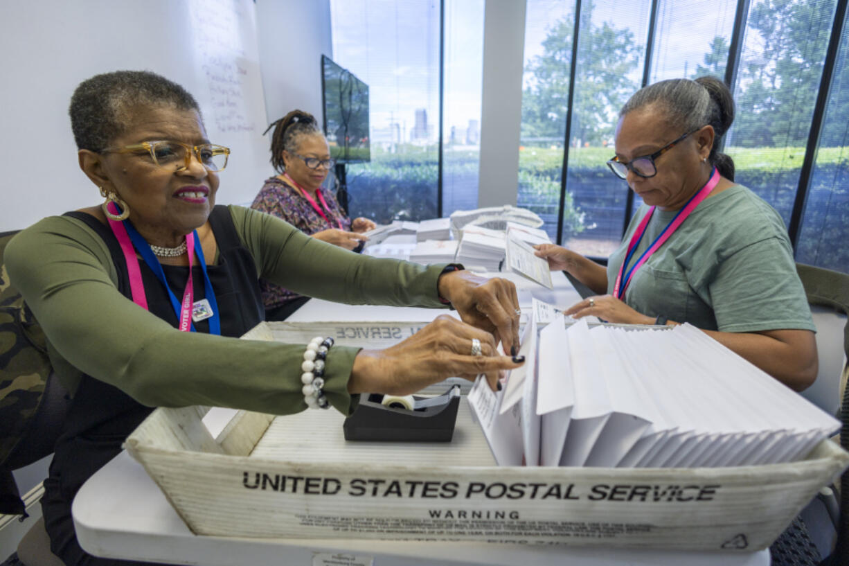 From left, Carol Hamilton, Cristo Carter and Cynthia Huntley prepare ballots to be mailed at the Mecklenburg County Board of Elections in Charlotte, N.C., Sept. 5, 2024.